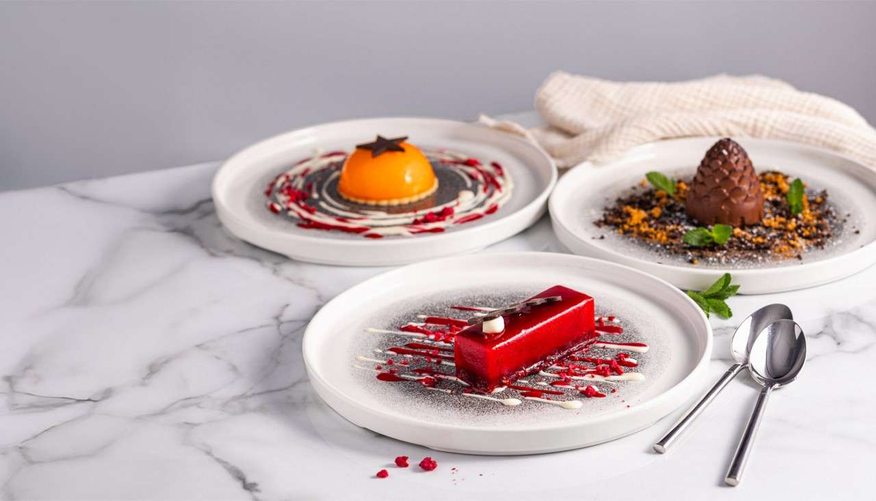 Cakes and desserts including fruit tarts and a chocolate pudding.