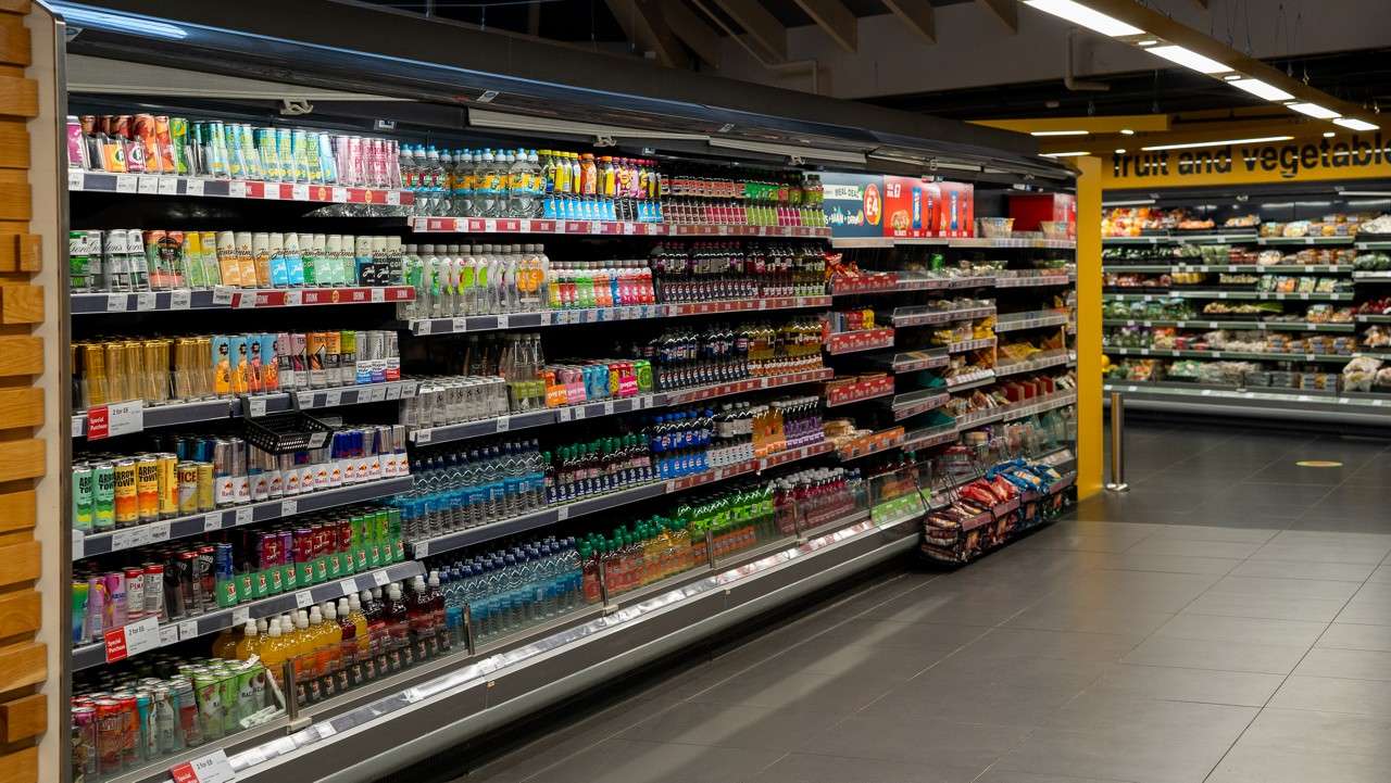 Inside the Parc Market shop a row with shelves of drink options