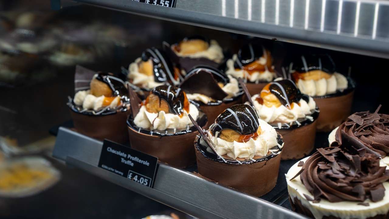 Chocolate profiterole truffles on display on a shelf inside Parc Market shop