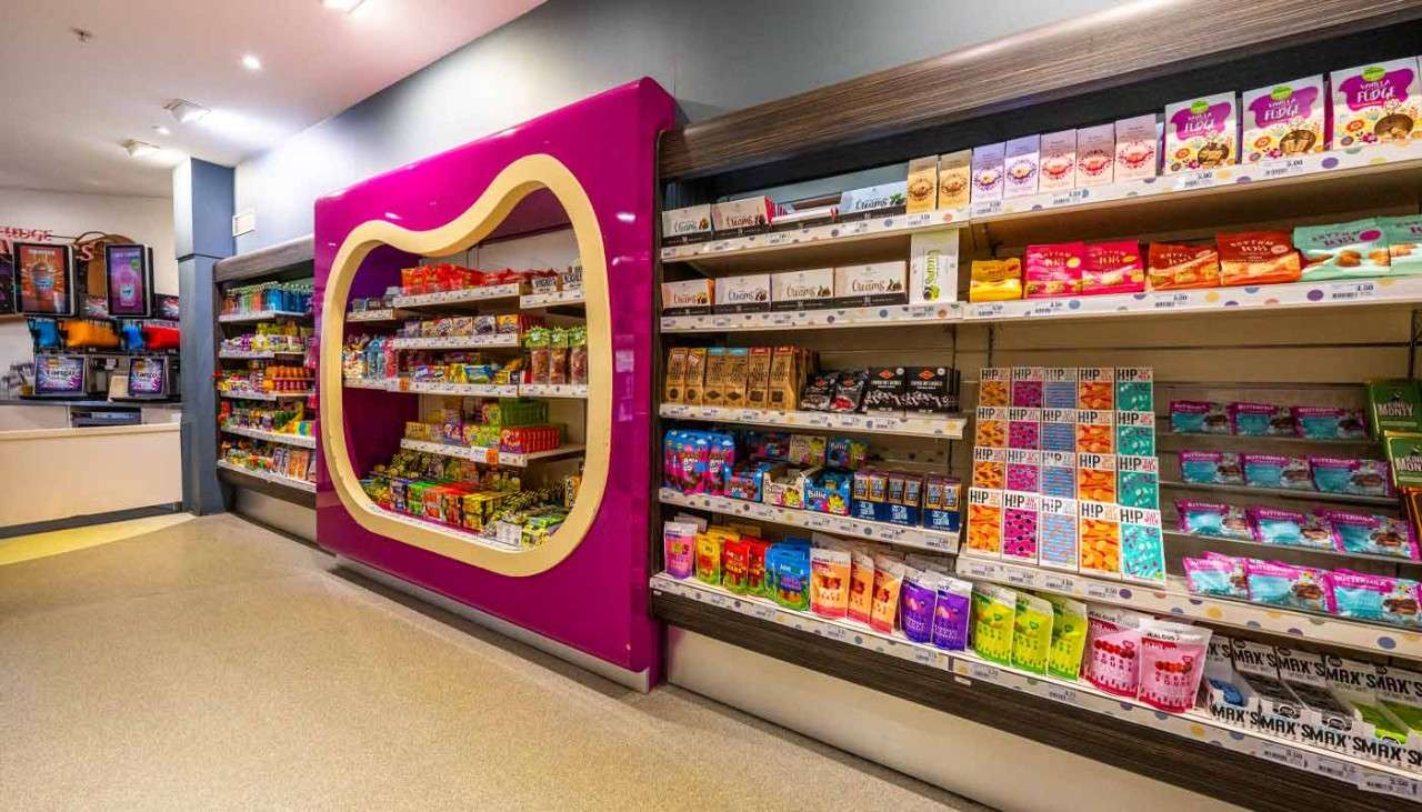 Shelves stacked with colourful packets of sweets and chocolate.