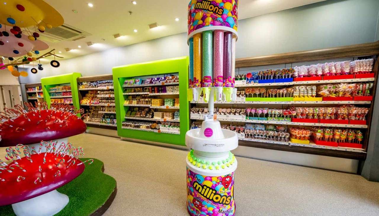 Inside the colourful Treats shop with mushroom lollies and a millions dispenser.