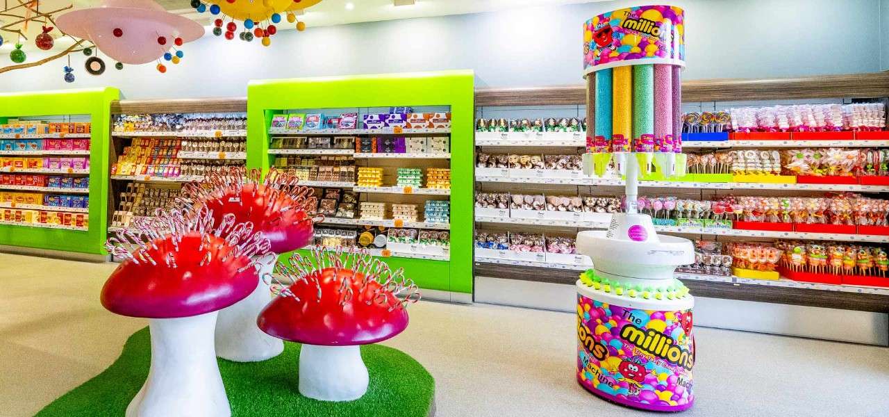 Inside the colourful Treats shop with a selection of sweet treats.