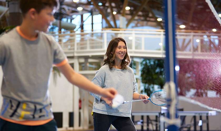 Mother and her son playing indoor badminton at Whinfell Forest.