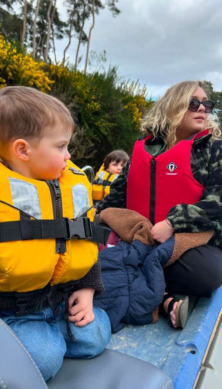 A family on a boat on the lake.
