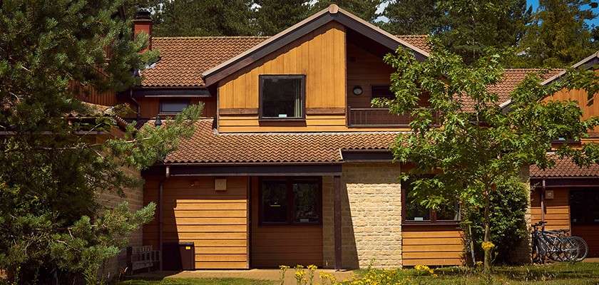 The exterior of a lodge in the forest at Center Parcs.