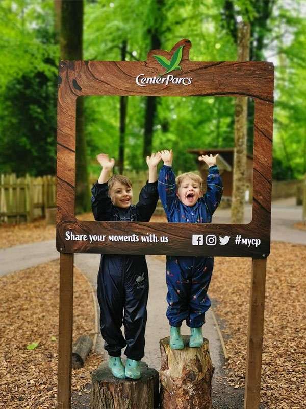 Two boys posing behind a Center Parcs photo frame.