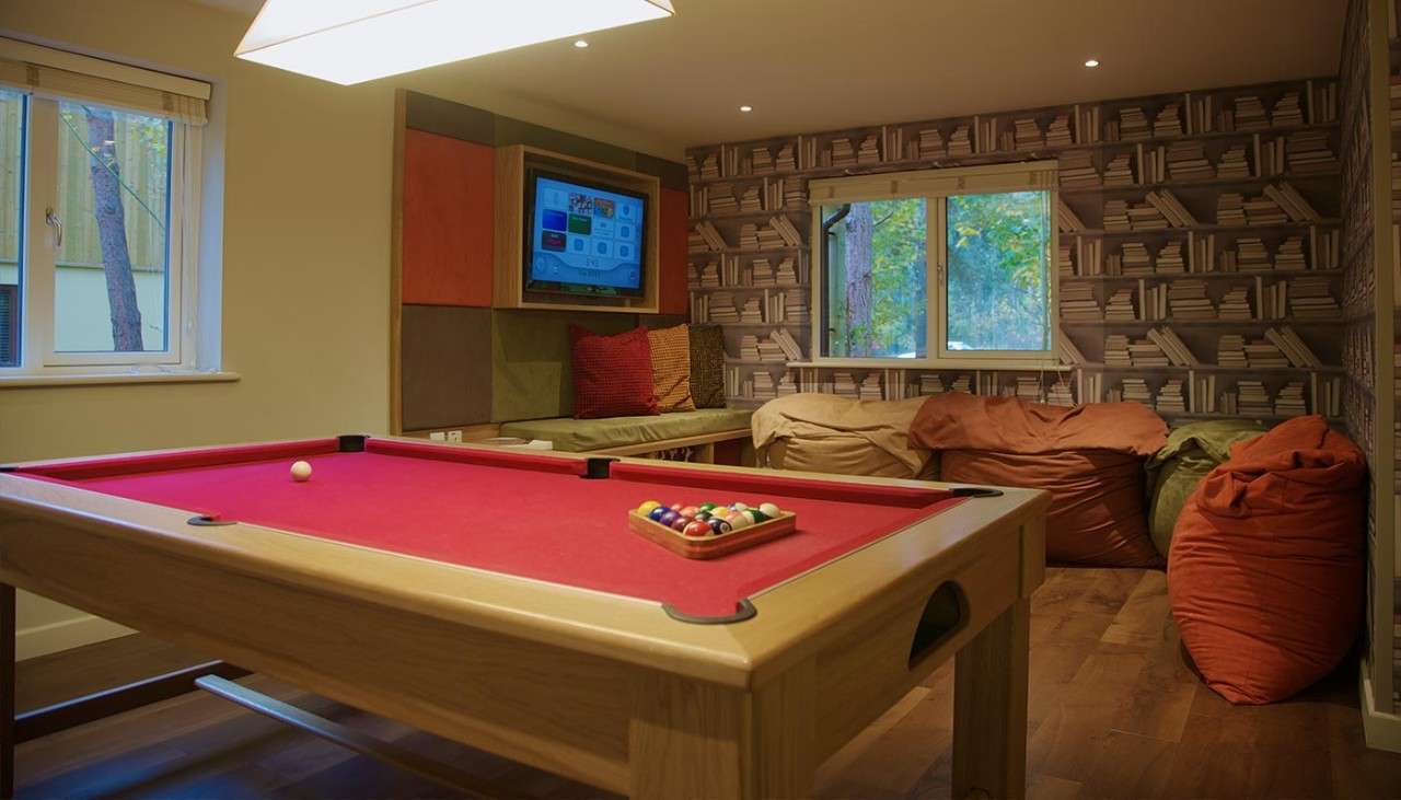 A pool table in a games room in a lodge.