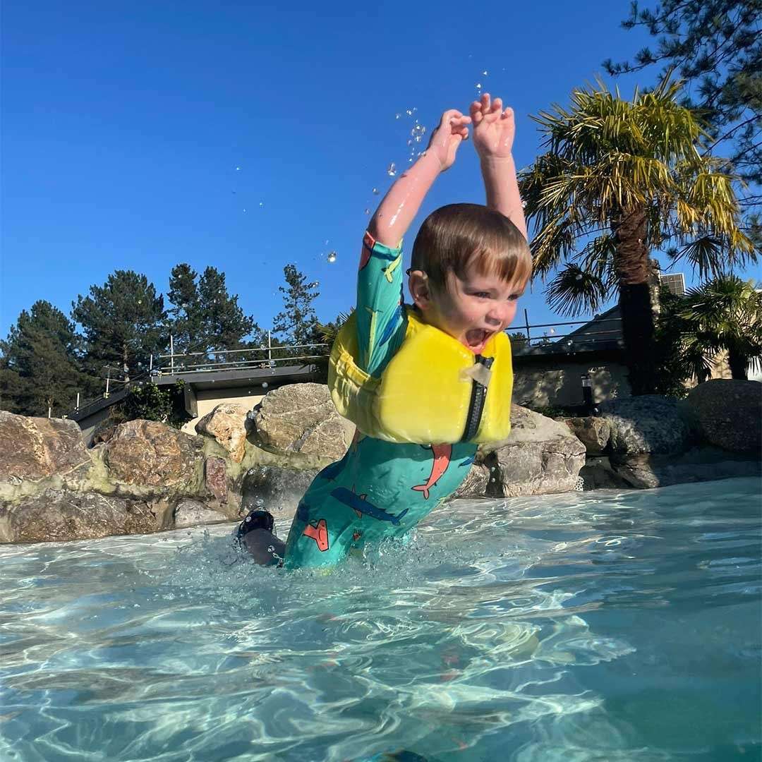 A little boy jumping in to the Subtropical Swimming Paradise