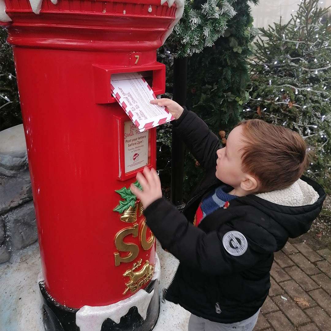 Boy posting his letter to Santa.