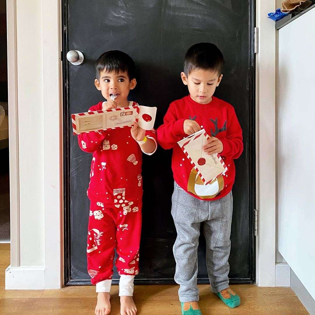 Two boys holding their letters to Santa.