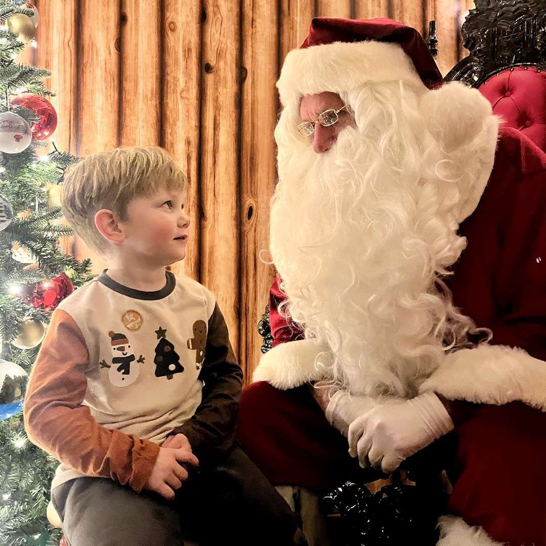 A little boy looking at Santa