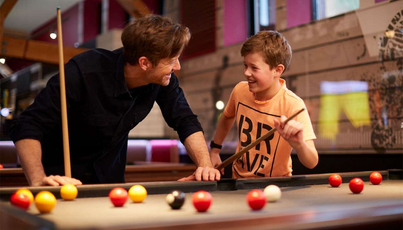 Man and boy playing pool