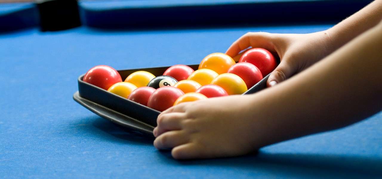 Pool balls being laid on the pool table