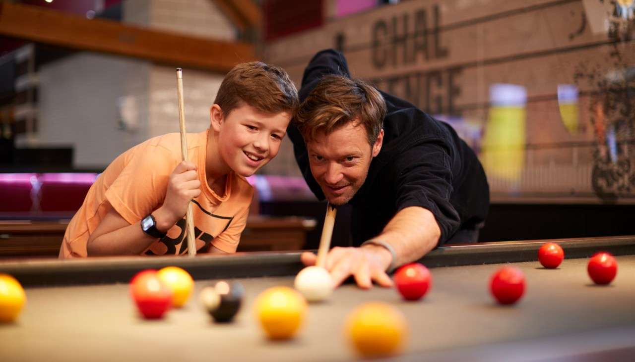 Man and boy playing pool