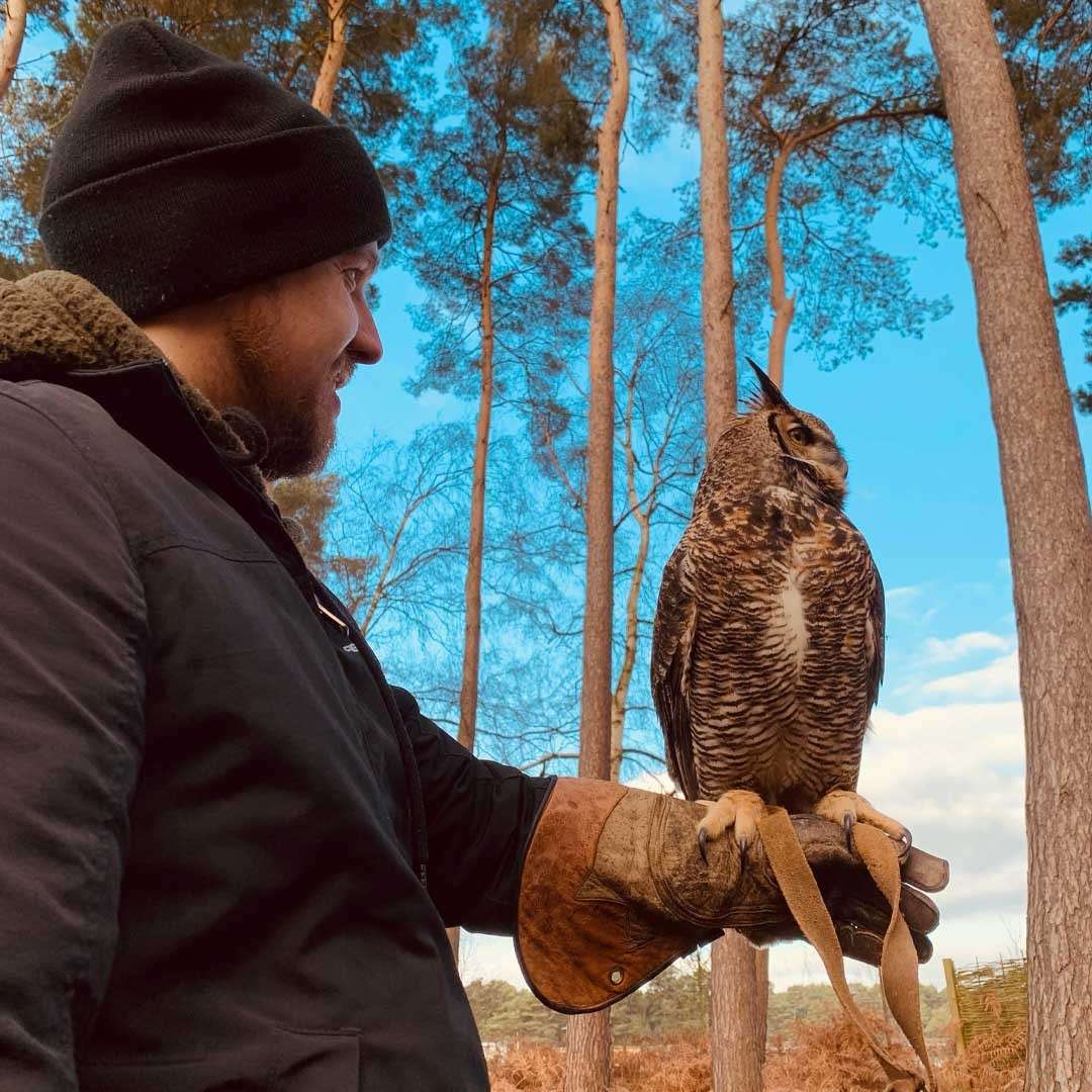 Man with an owl sat on his arm