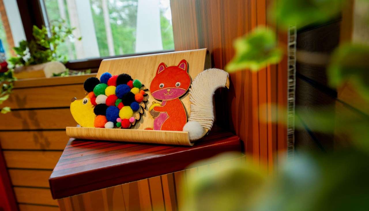 Wooden hedgehog and fox presented on the 'My Masterpiece' podium