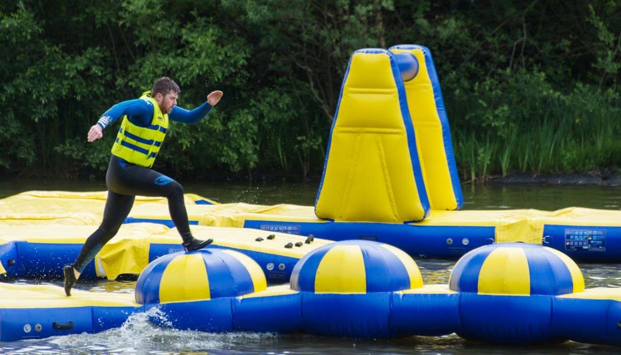 Man running across floating inflatable