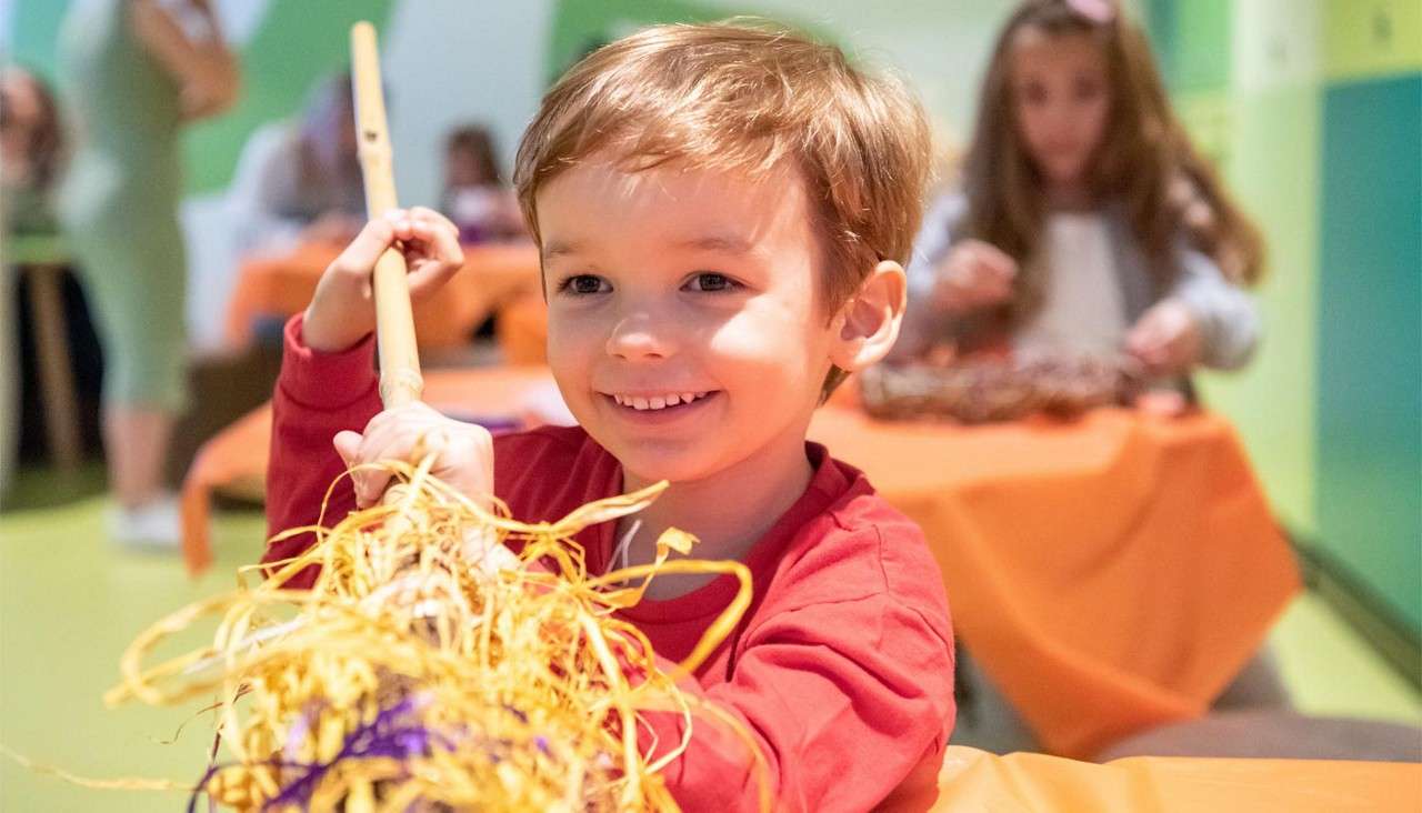 Young boy showing off his finished craft