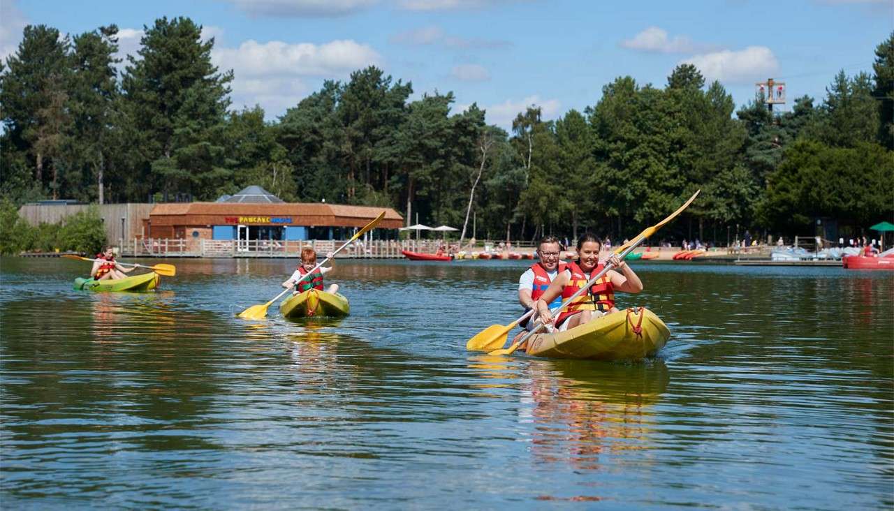 Couple sitting in a Double Kayak on the lake.