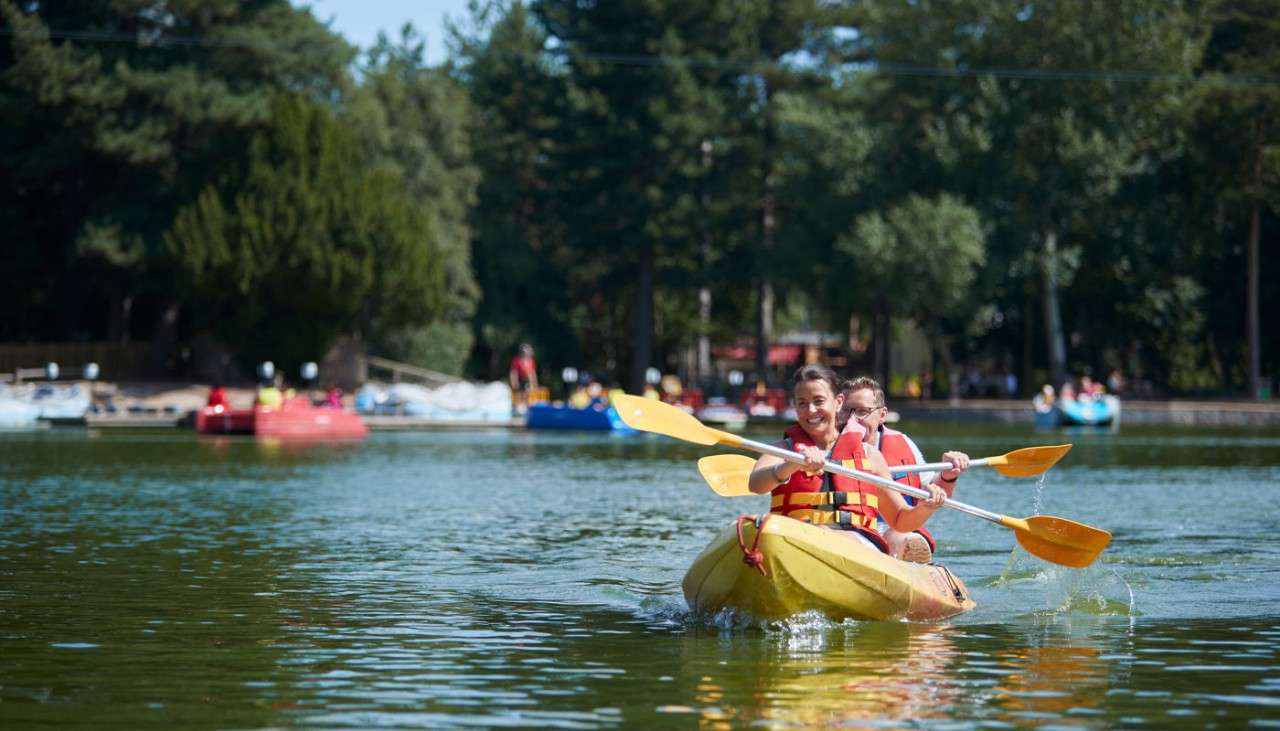 Couple sitting in a Double Kayak on the lake.