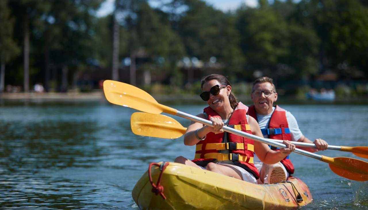 Couple sitting in a Double Kayak on the lake.