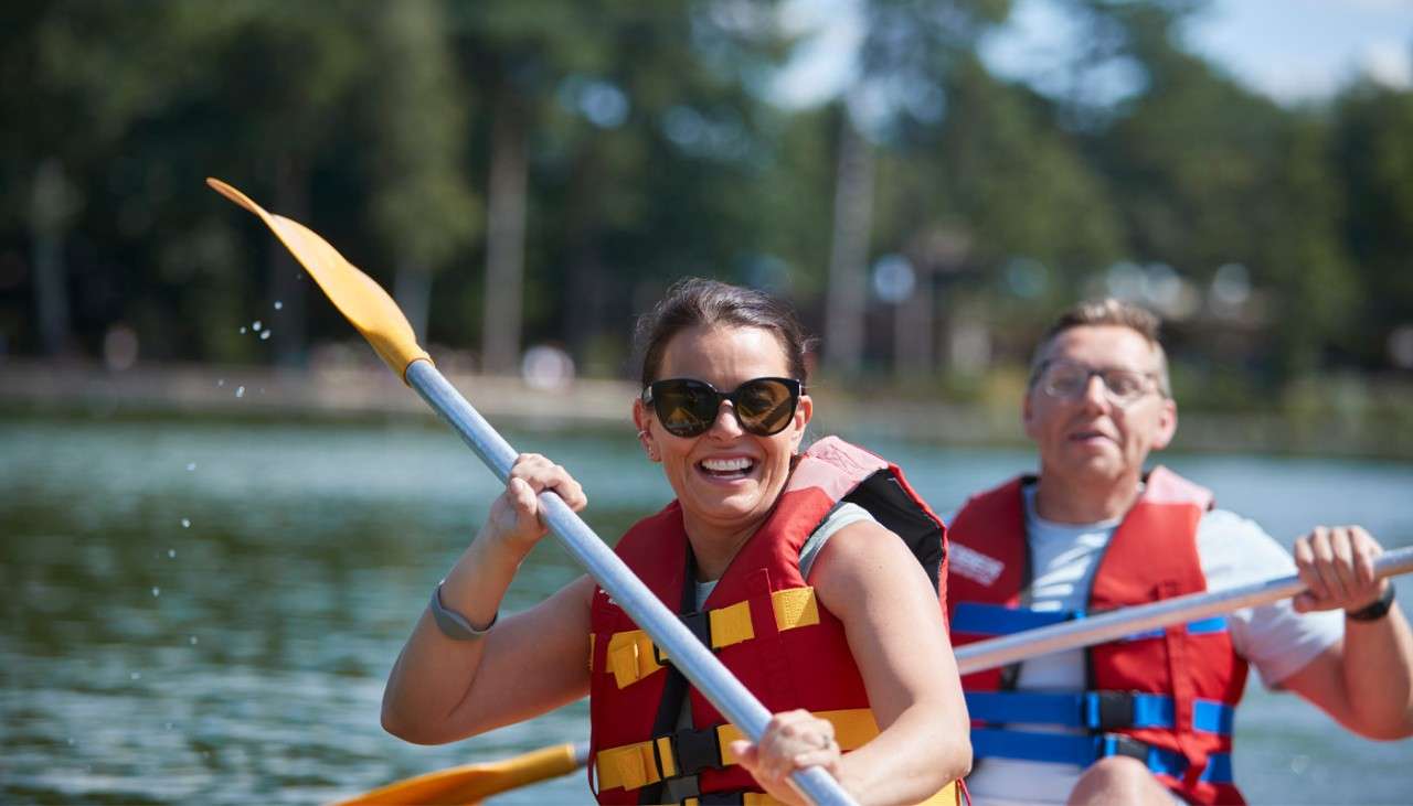 Couple sitting in a Double Kayak on the lake.