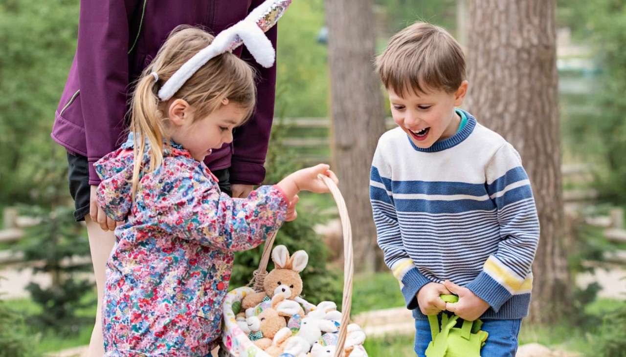 Boy and girl hunting for Easter eggs