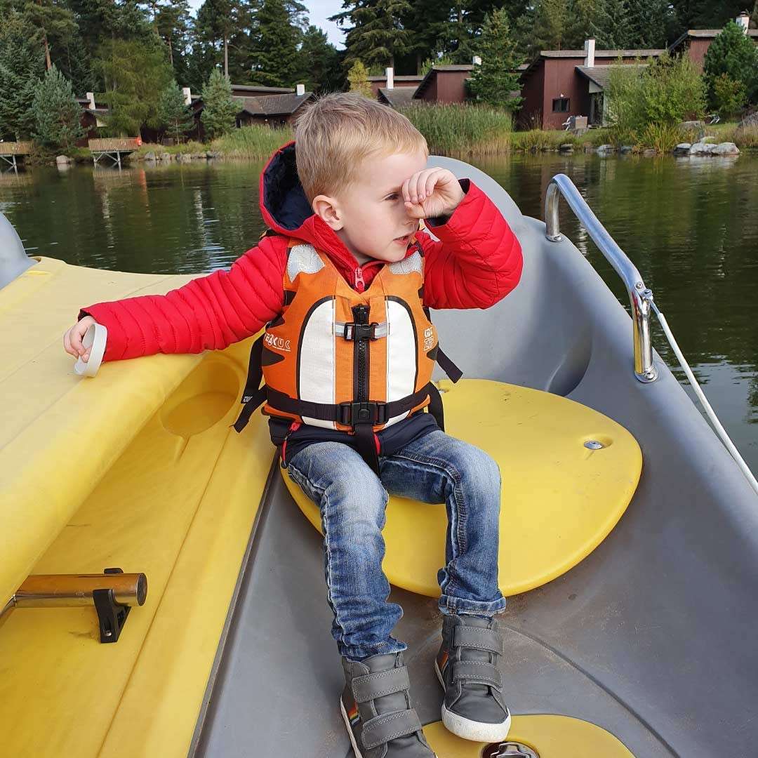 Young boy sitting in an Electric Boat on the lake