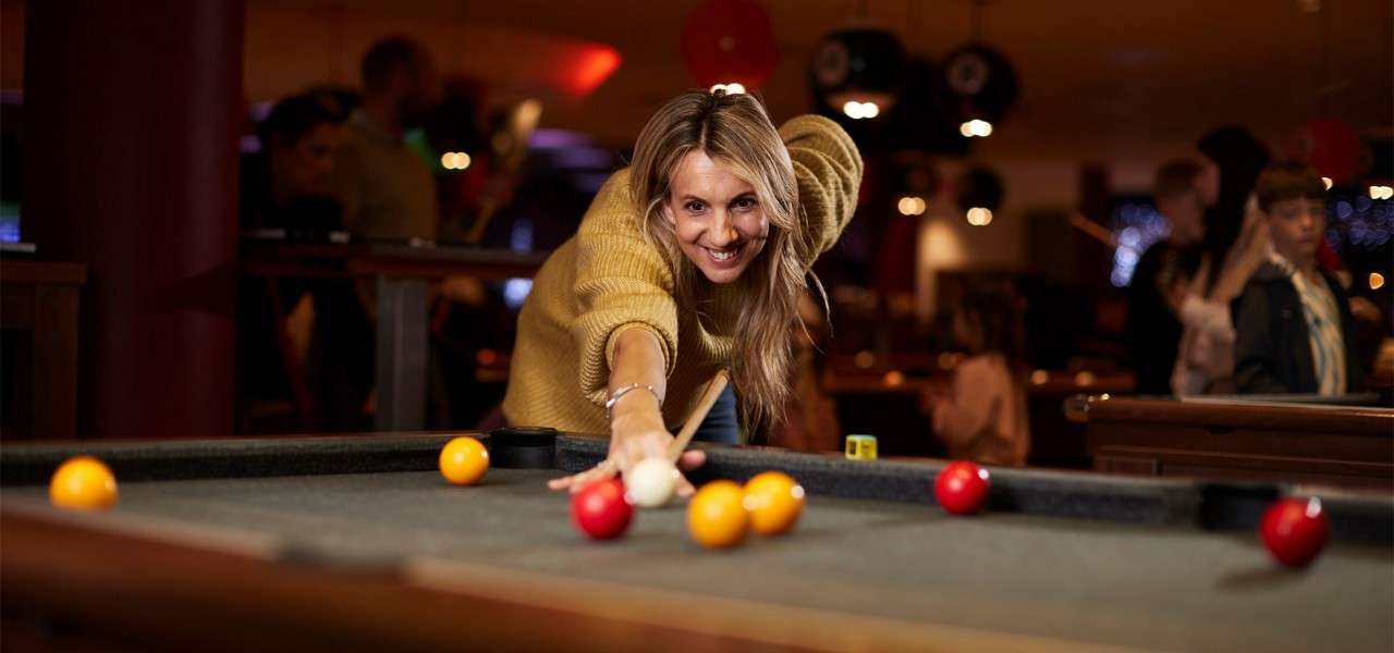 Woman playing pool.