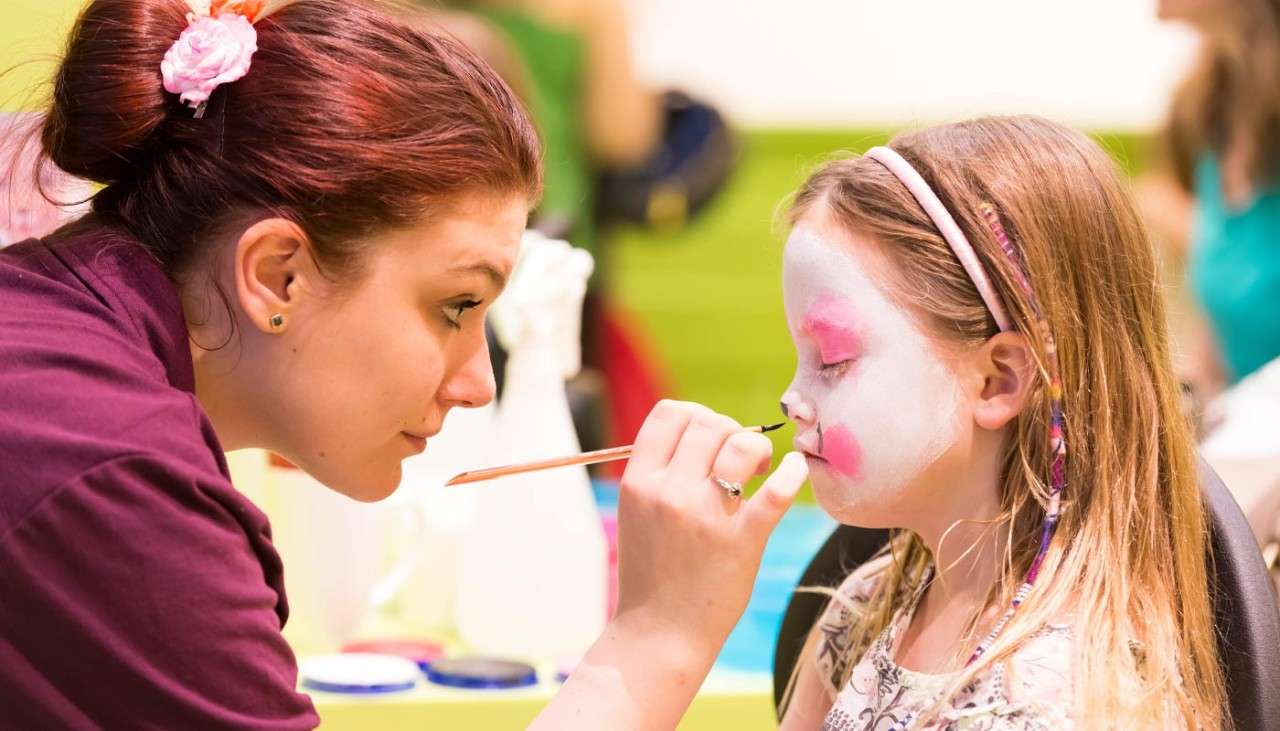 Girl having her face painted