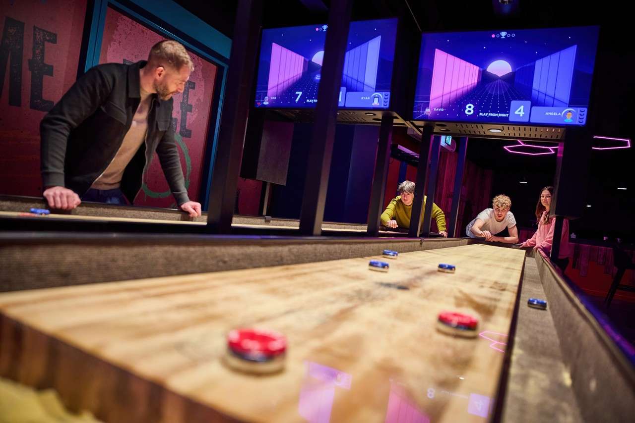 Group playing Interactive Shuffleboard.