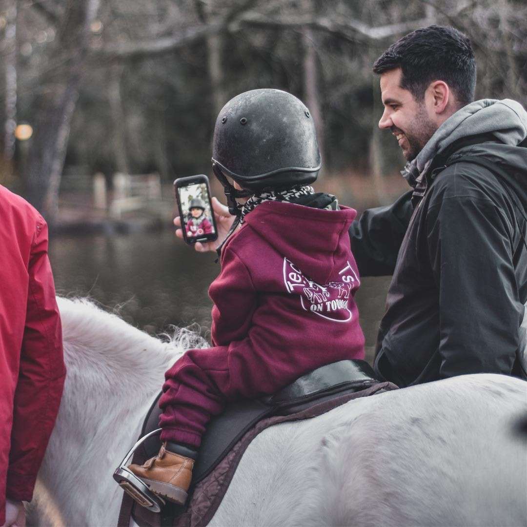 Young girl riding a pony