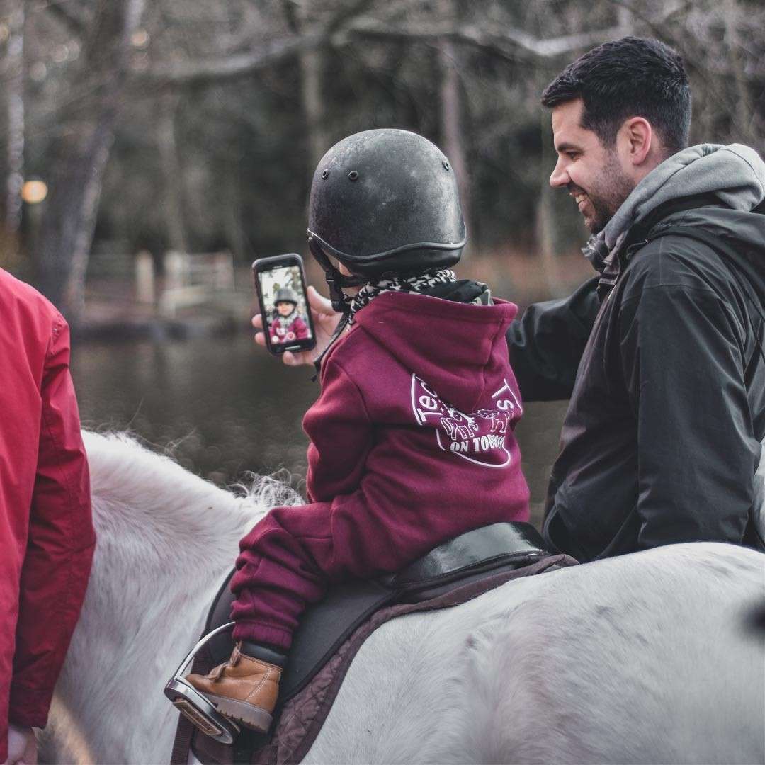 Young person riding on the back of a pony