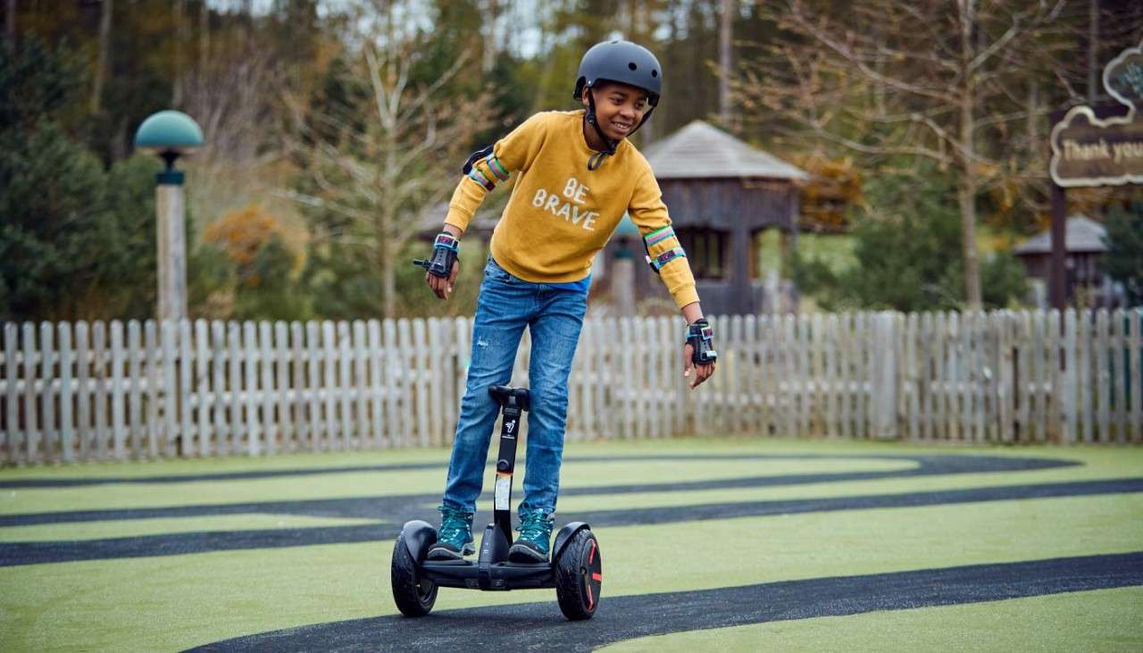 Young boy balancing on a mini Segway