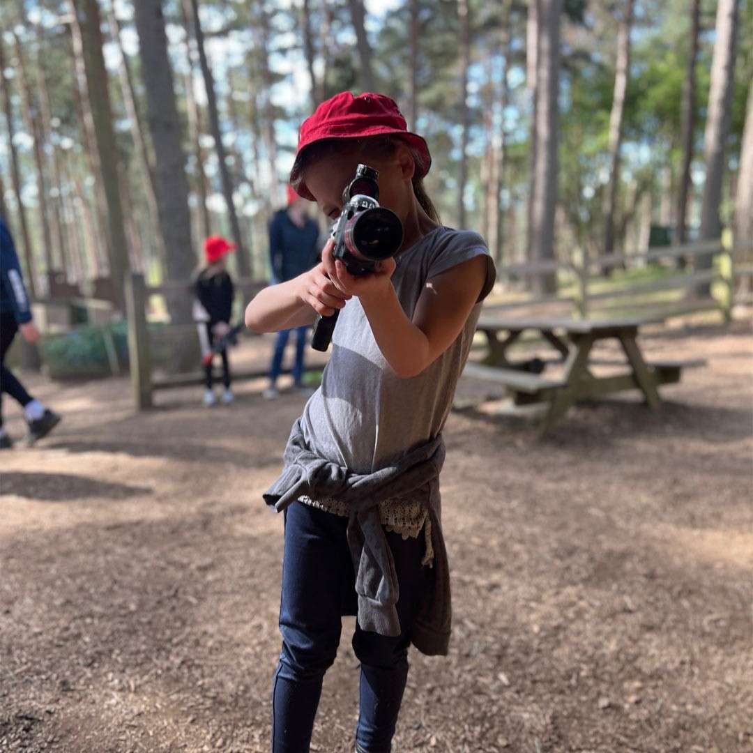 Young girl holding a Laser Combat gun