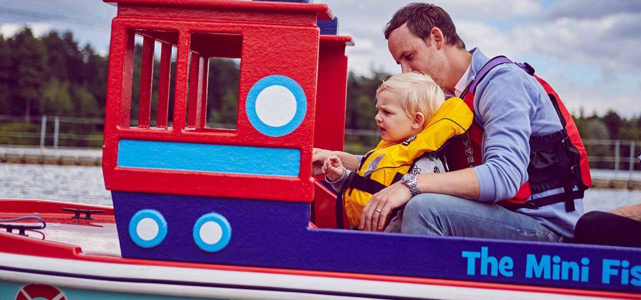 Man and child in children's boat