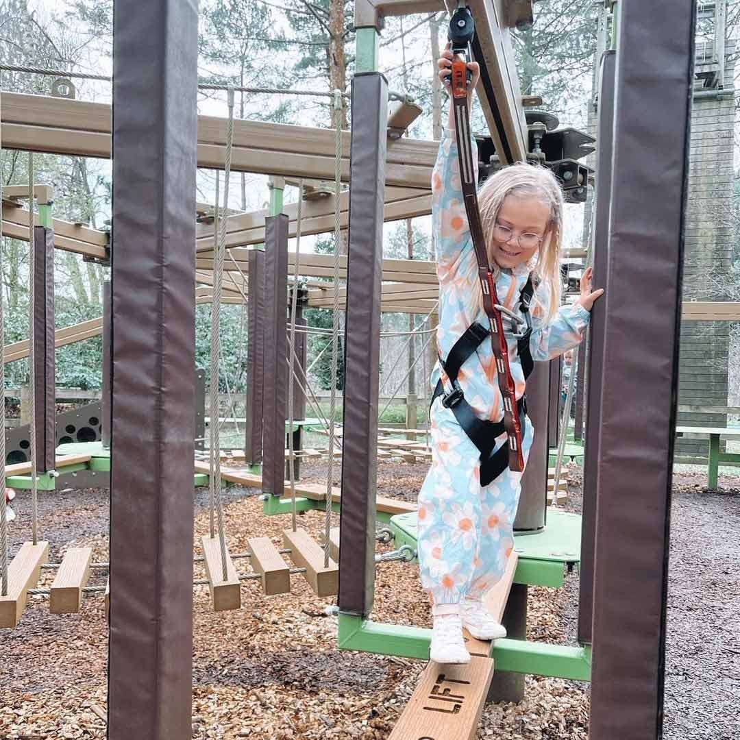 Young girl balancing on a beam