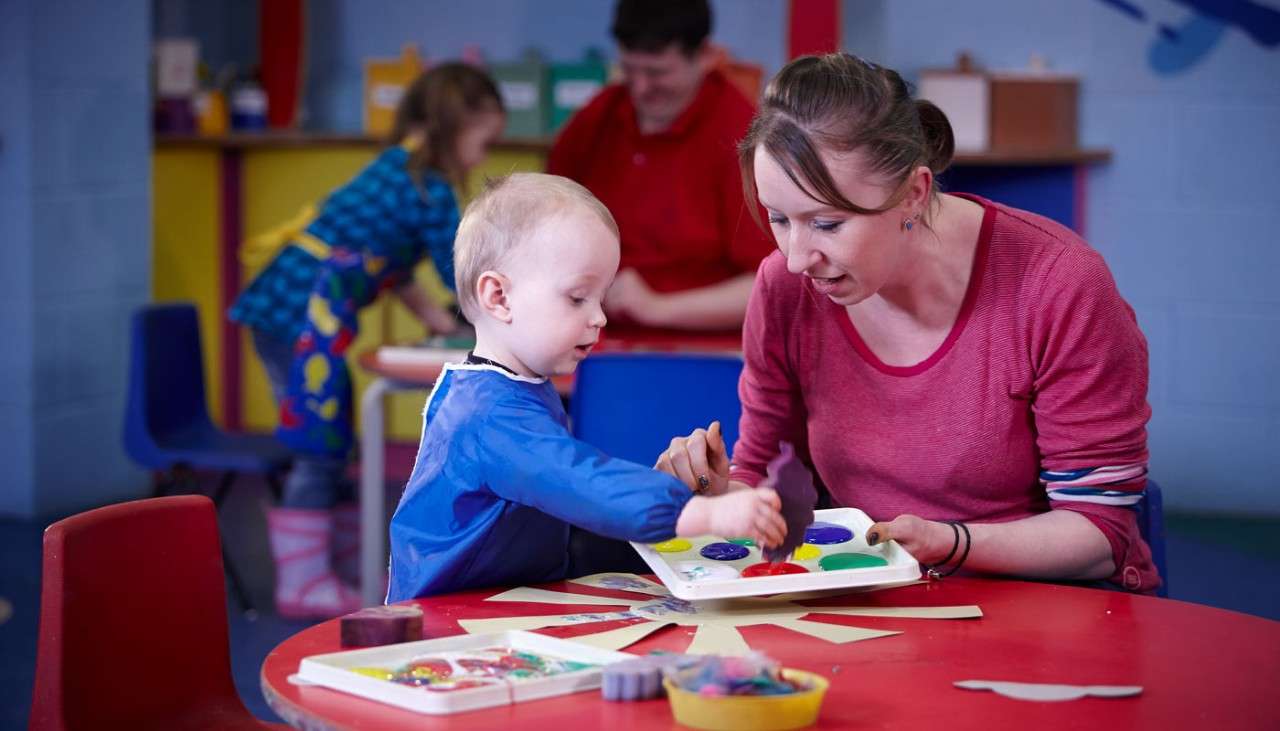 Woman and young boy painting 