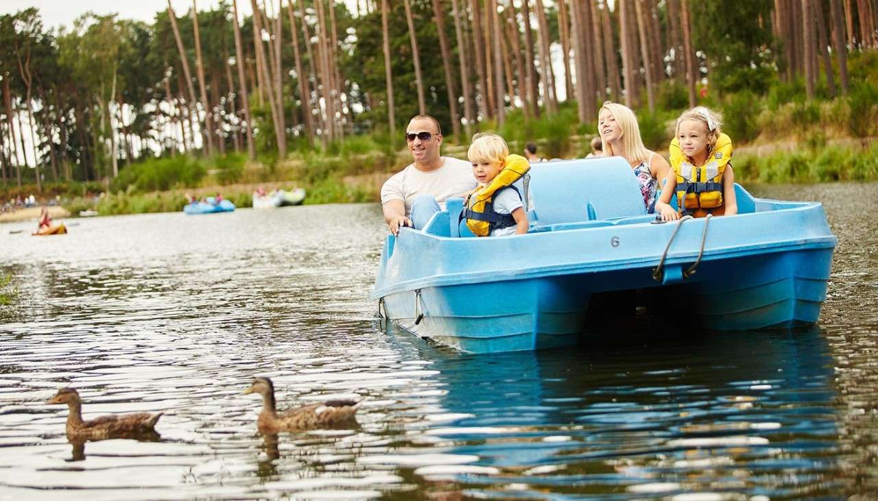 Family sitting in a Pedalo on the lake