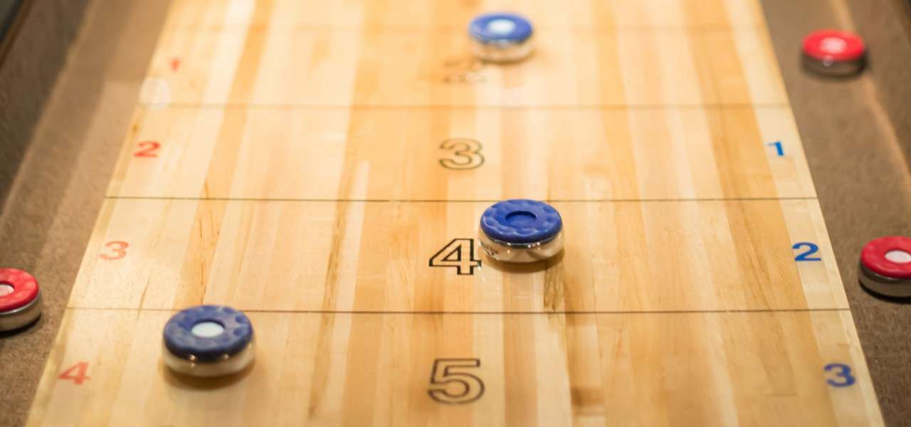 Shuffleboard pieces on a wooden table.
