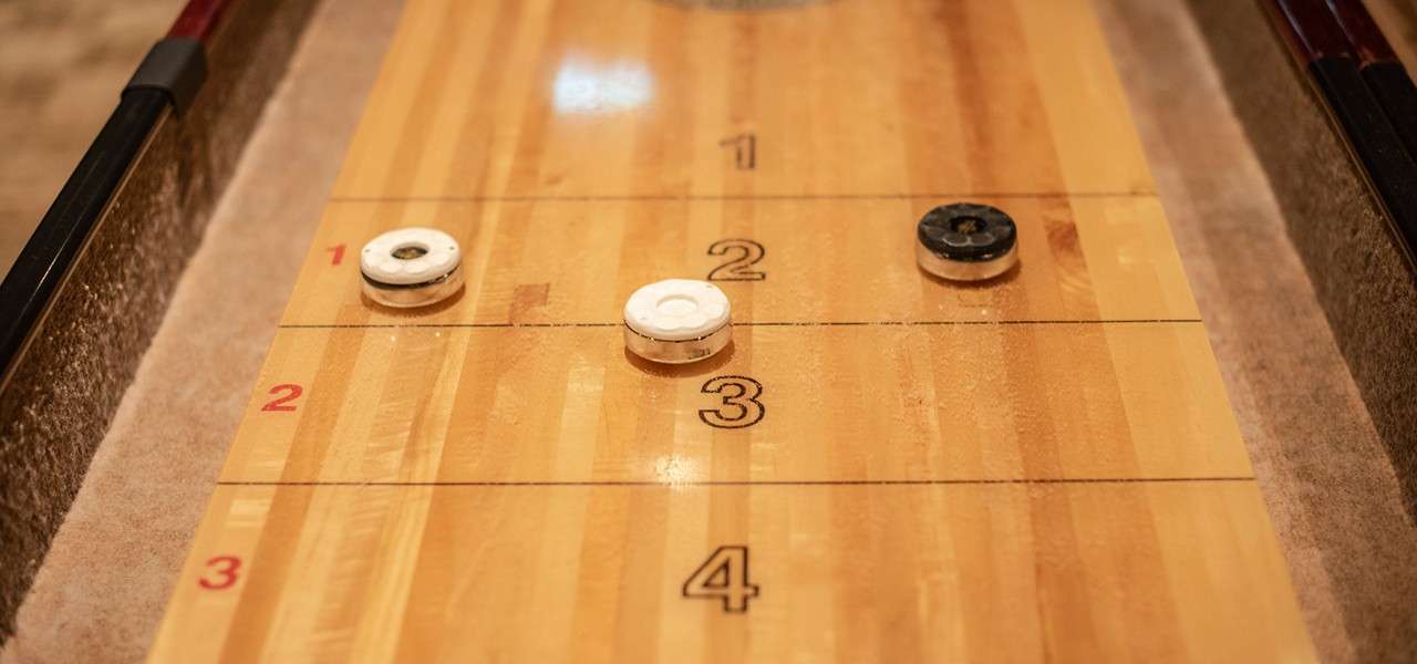 Shuffleboard pieces on a wooden table.