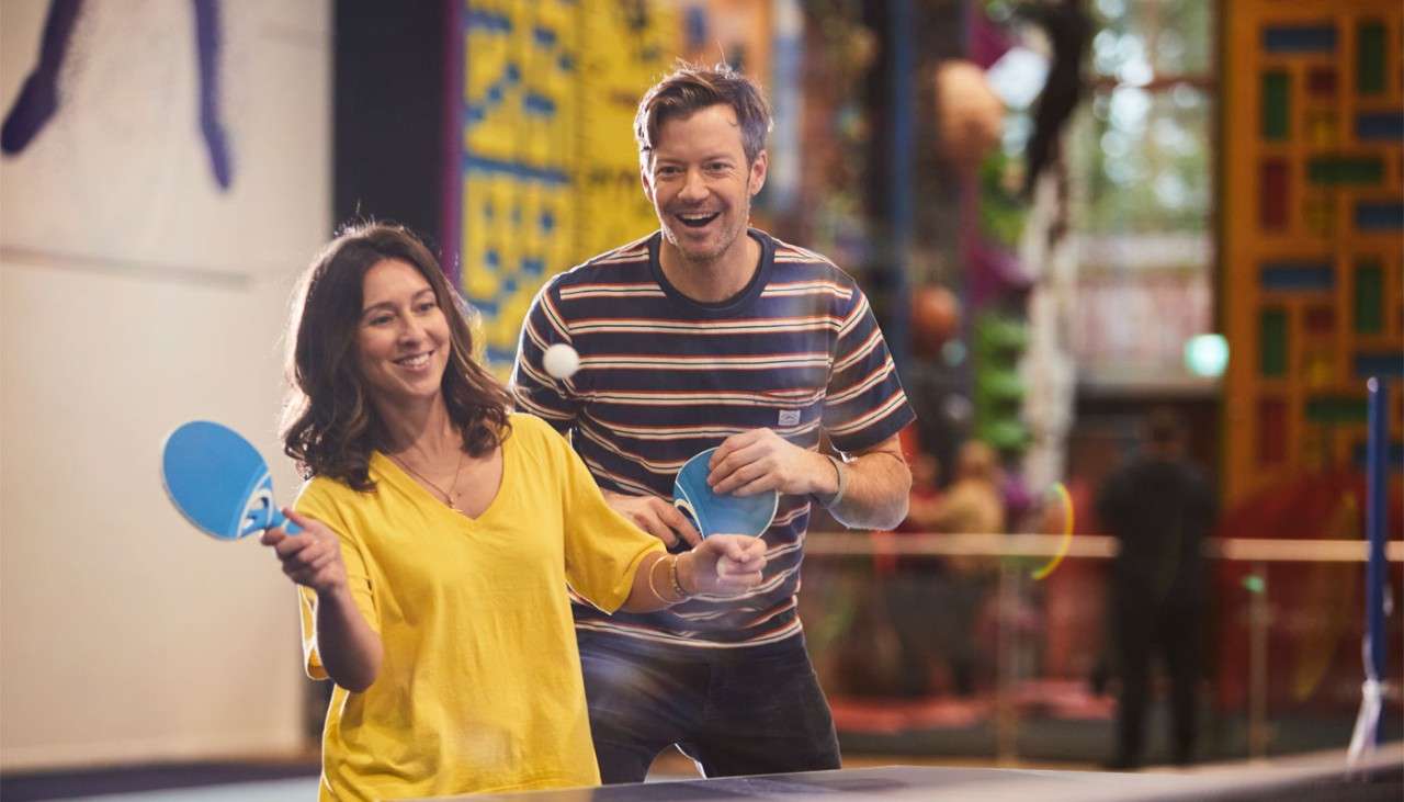 Couple playing table tennis