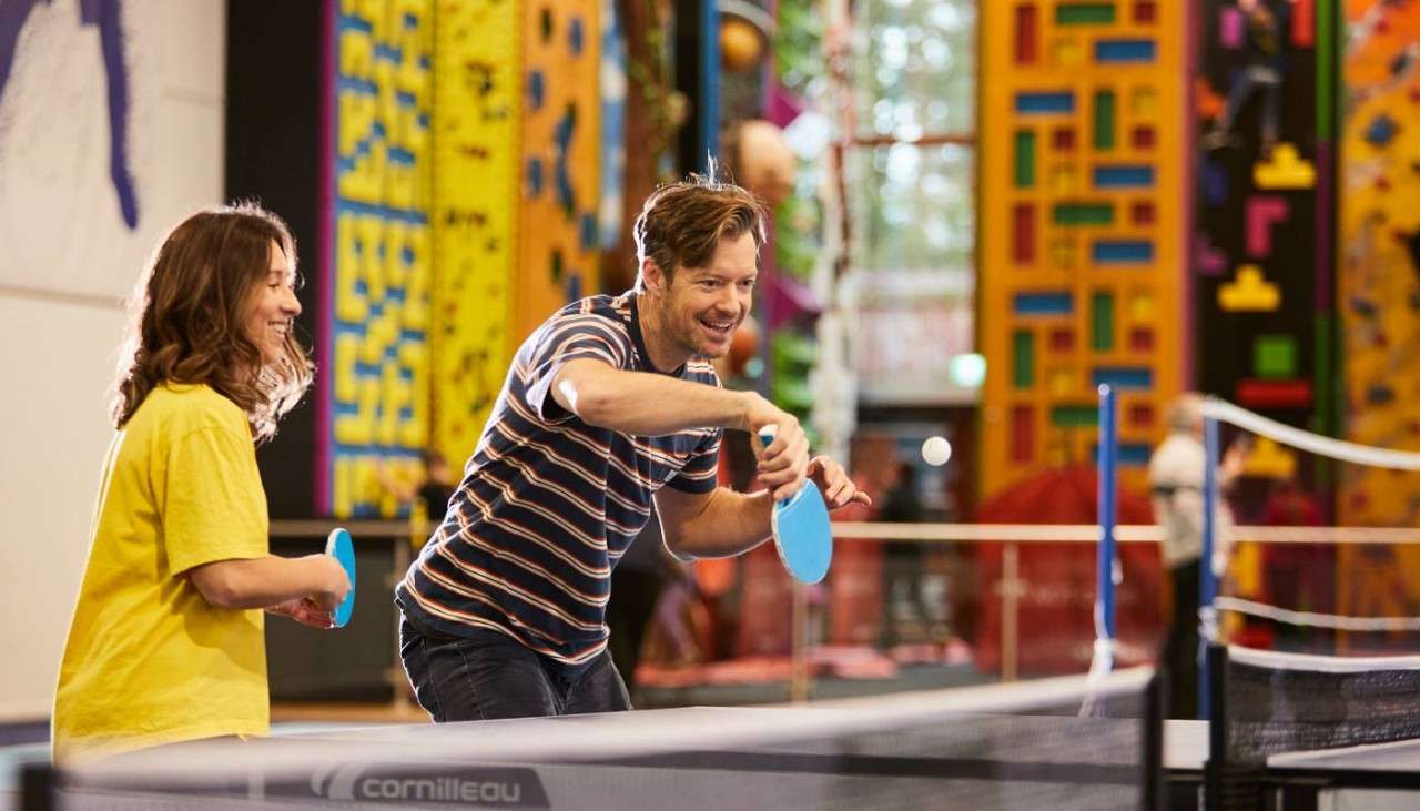 Couple playing table tennis