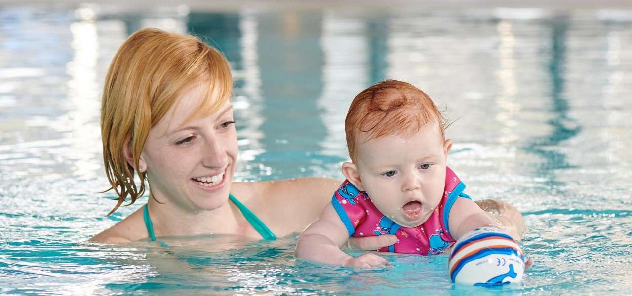 A mother and her infant swimming together