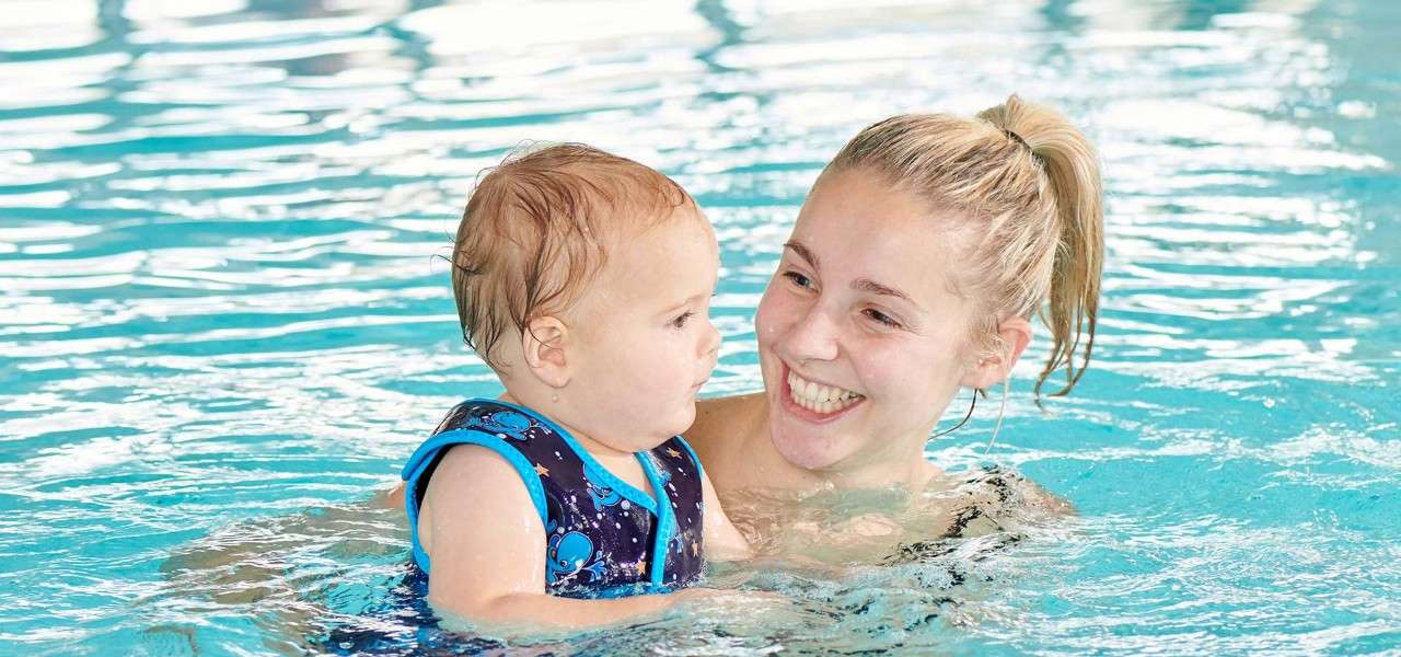 A mother and her infant swimming together
