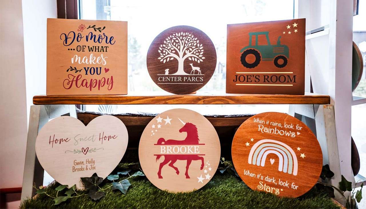 A selection of decorated wooden plaques.