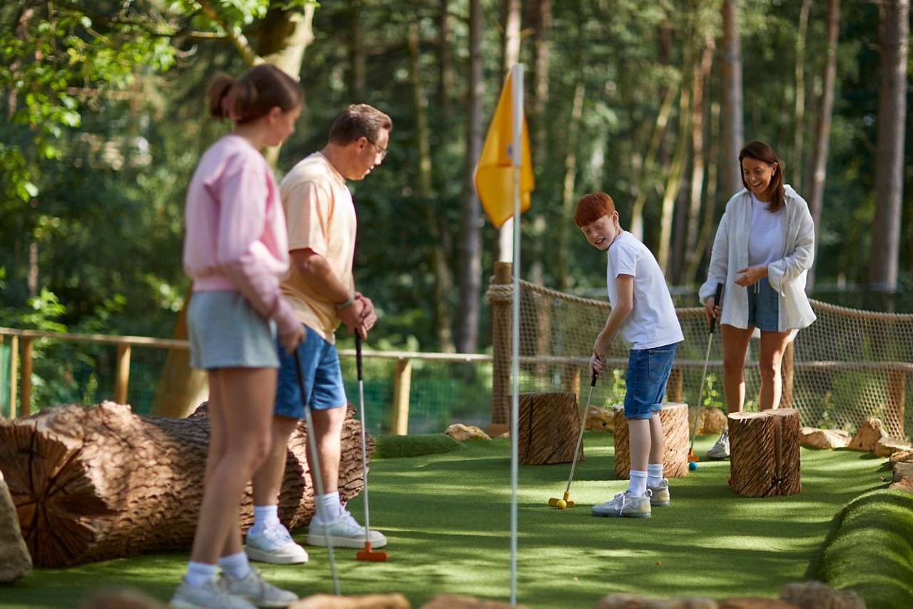 A teen getting ready to put his golf ball