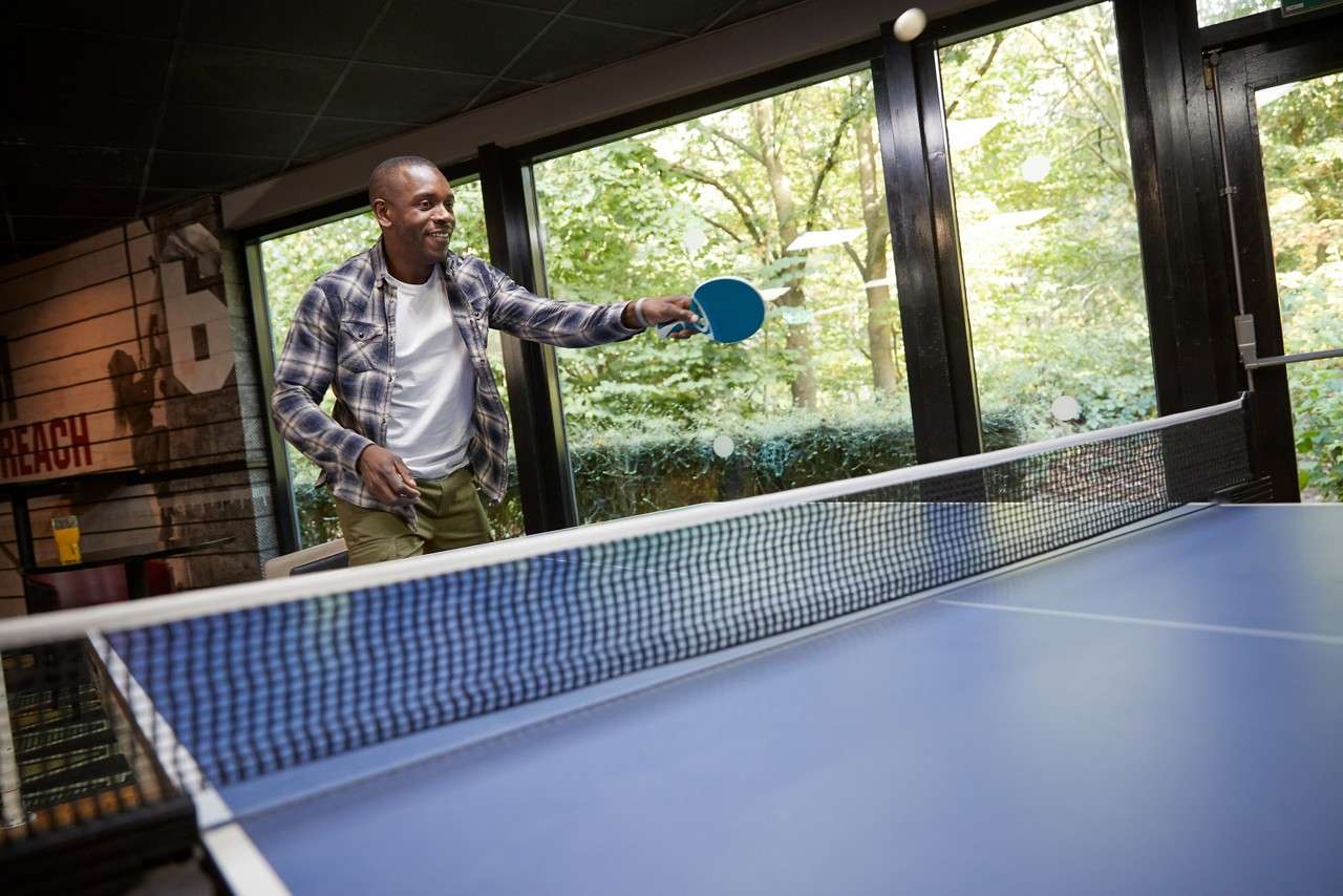 Man holding a ping pong racket.
