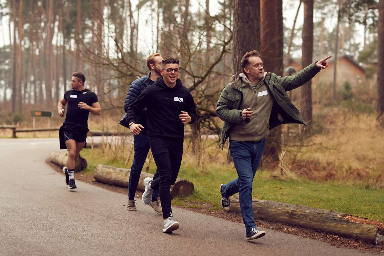 A family running through the forest as part of geocache