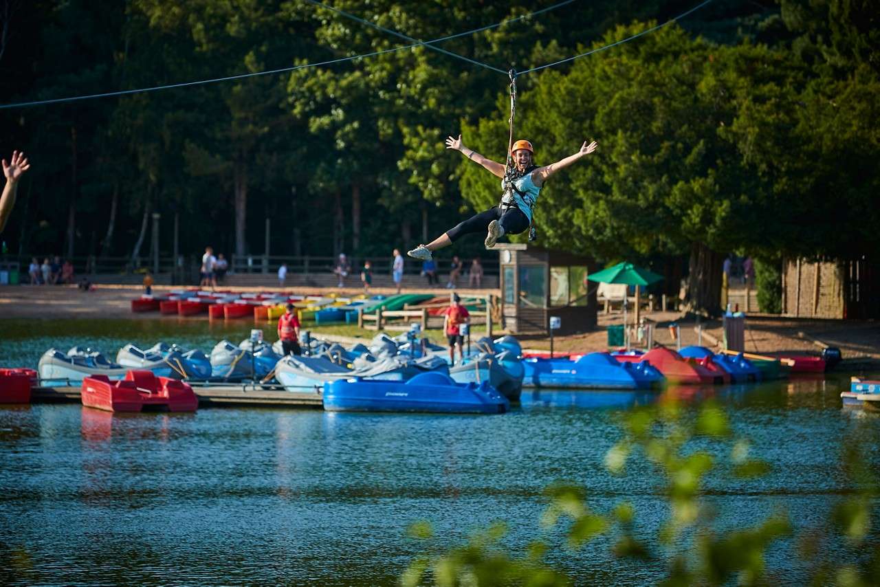 Two people flying down the zip line